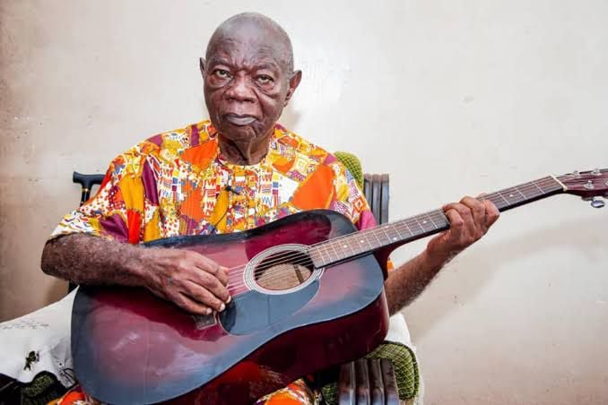 Mike Ejeagha Playing Guitar